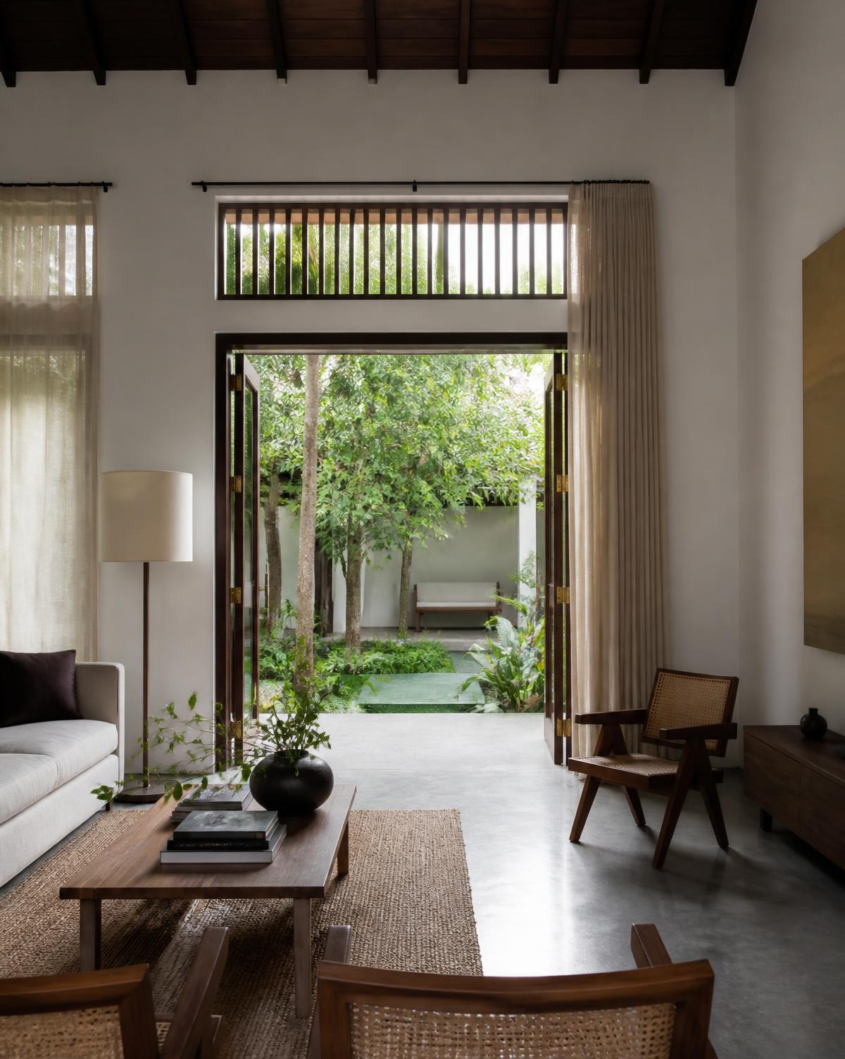 Interior of a modern Sri Lankan villa opening onto a green courtyard
